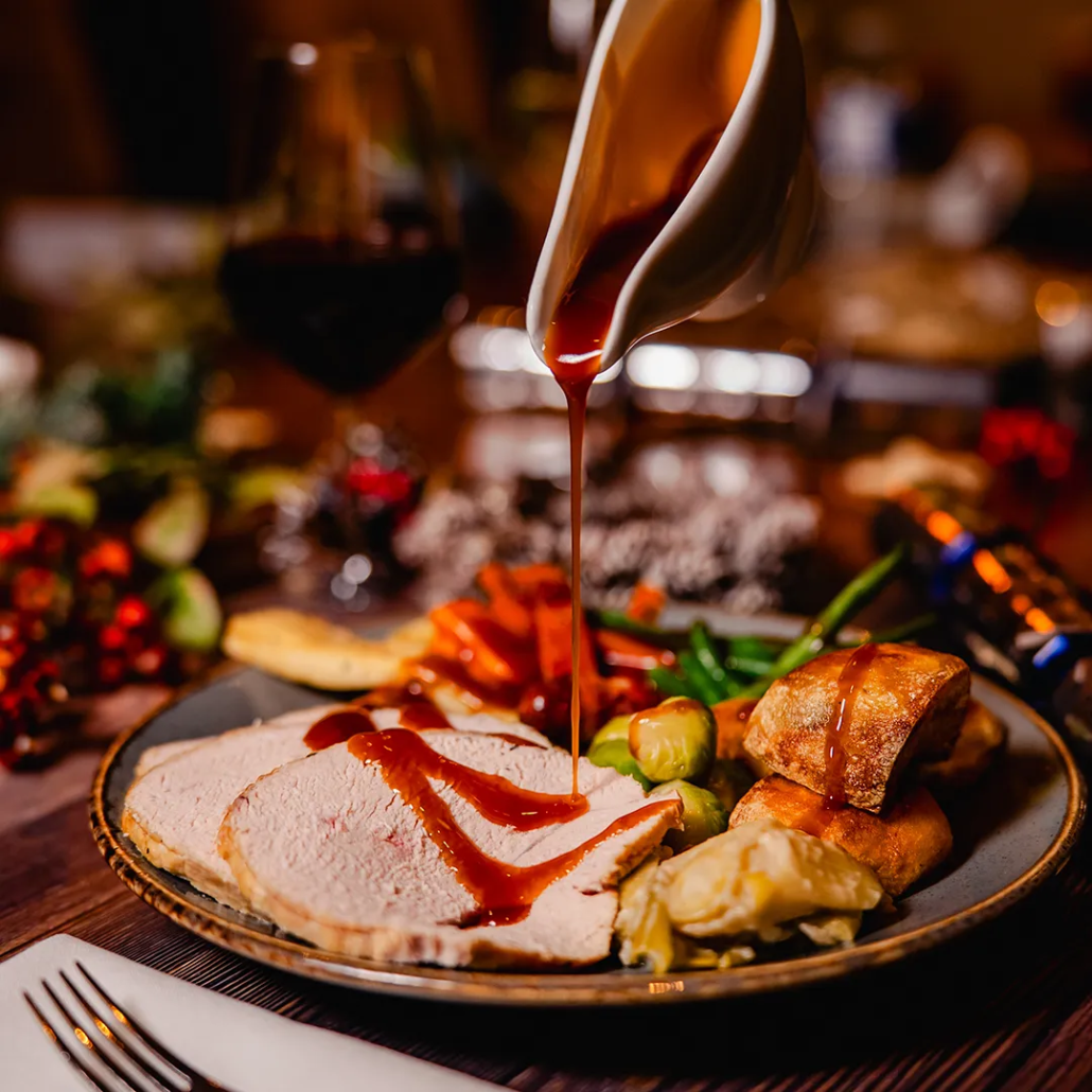 Hand Carved Turkey Breast Traditional turkey with sage & onion stuffing, chipolata pig in blanket and rich gravy. Served with roasted potatoes, Brecon honey roasted parsnip, Welsh buttered Brussels sprouts, carrots & spiced braised red cabbage.