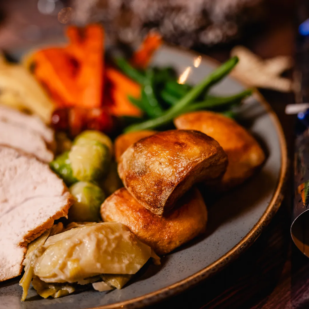 Hand Carved Turkey Breast Traditional turkey with sage & onion stuffing, chipolata pig in blanket and rich gravy. Served with roasted potatoes, Brecon honey roasted parsnip, Welsh buttered Brussels sprouts, carrots & spiced braised red cabbage.