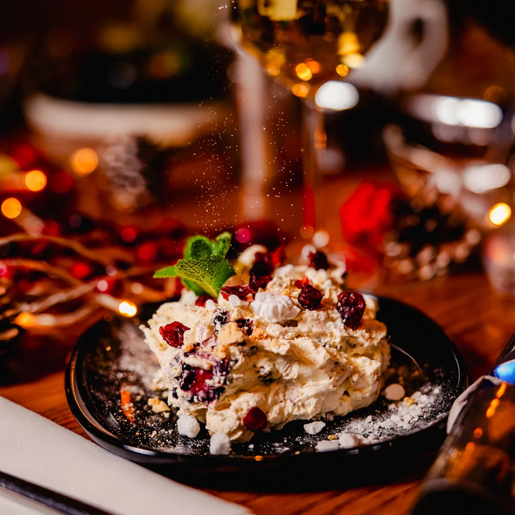 Snowball Smash Crisp meringue pieces with blackberries, cranberries & amaretti biscuit folded into cinnamon whipped cream.