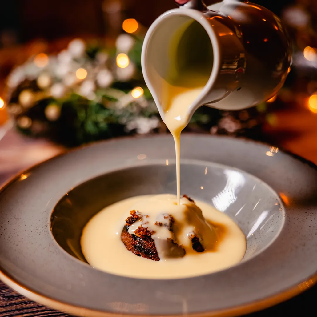 Traditional Christmas Pudding Classic festive pudding served with warm brandy sauce.